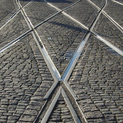 The bot's profile picture: tram tracks crossing over cobblestones